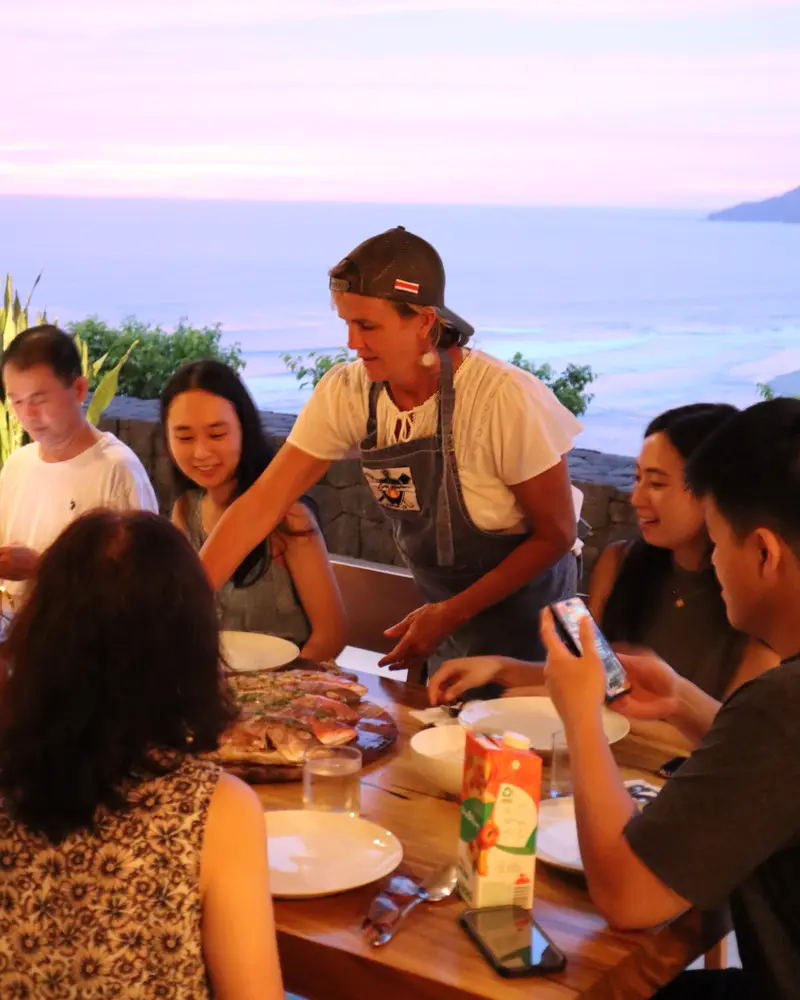 Grill Master chef serving dinner to guests at an ocean-view vacation home in Tamarindo