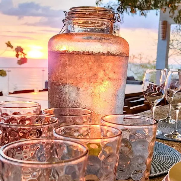 Sangria and glasses set for a sunset dinner overlooking the ocean