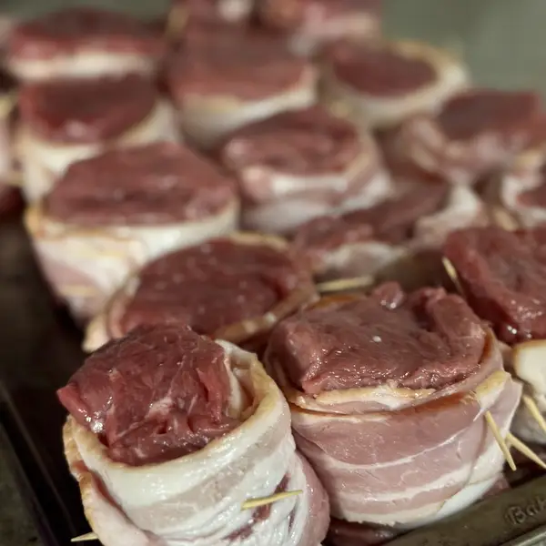 Bacon-wrapped beef tenderloin medallions ready to grill