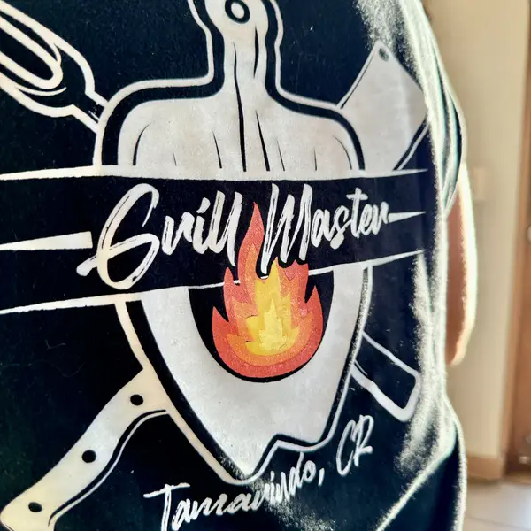 Grill Master Tamarindo apron with the flame logo