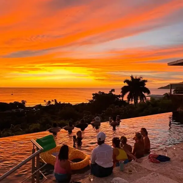 Guests watching the sunset over the pool in Tamarindo