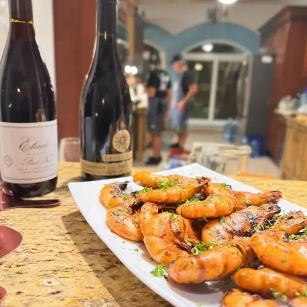Grilled prawns and red wine at a private dinner